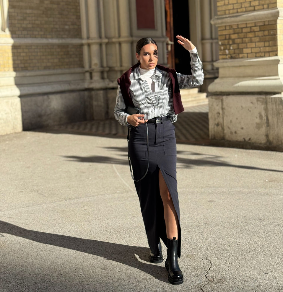 Woman in formal attire standing in front of a building