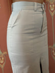 Light gray skirt with zippers on a patterned background