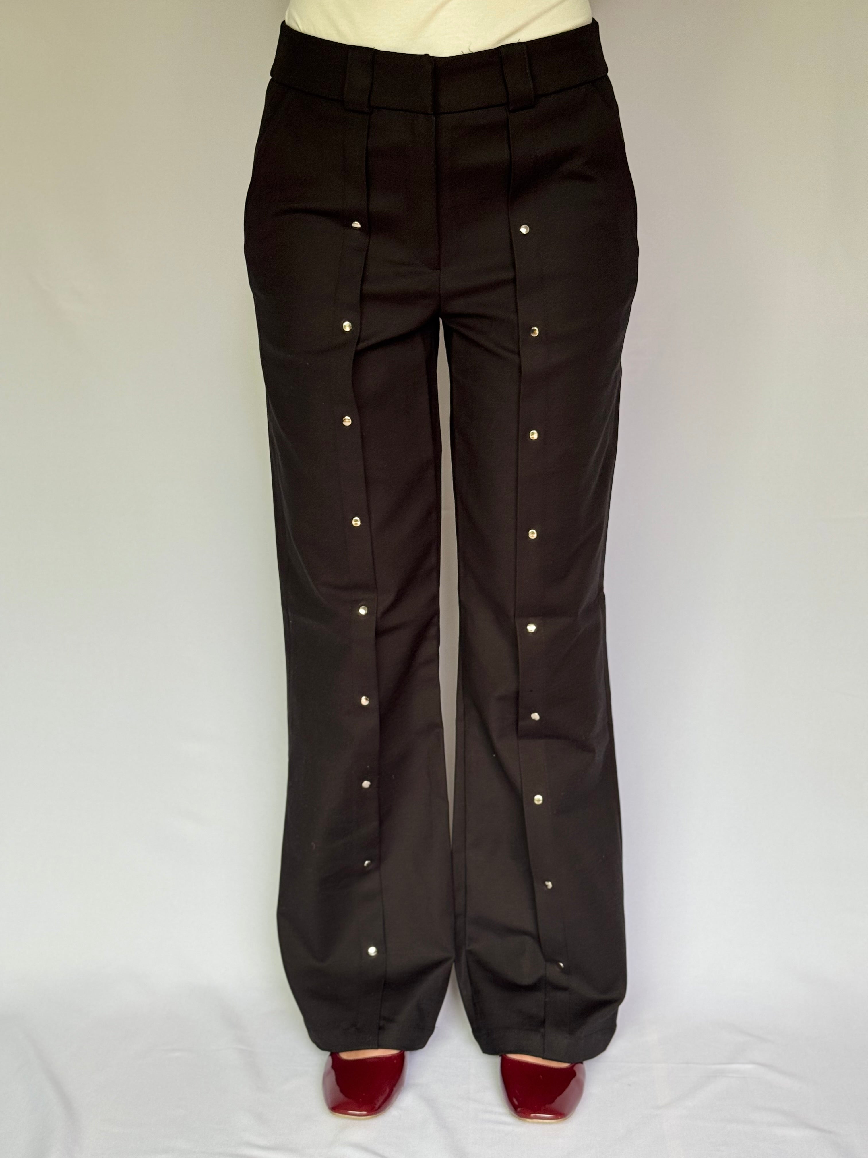 Black pants with drinker details on a white background