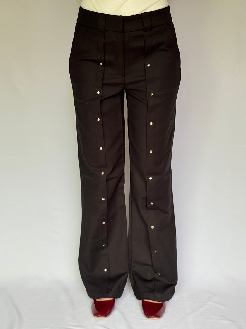 Black pants with drinker details on a white background